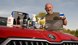 Auto Express products editor Tom Barnard standing with a selection of award-winning car care products